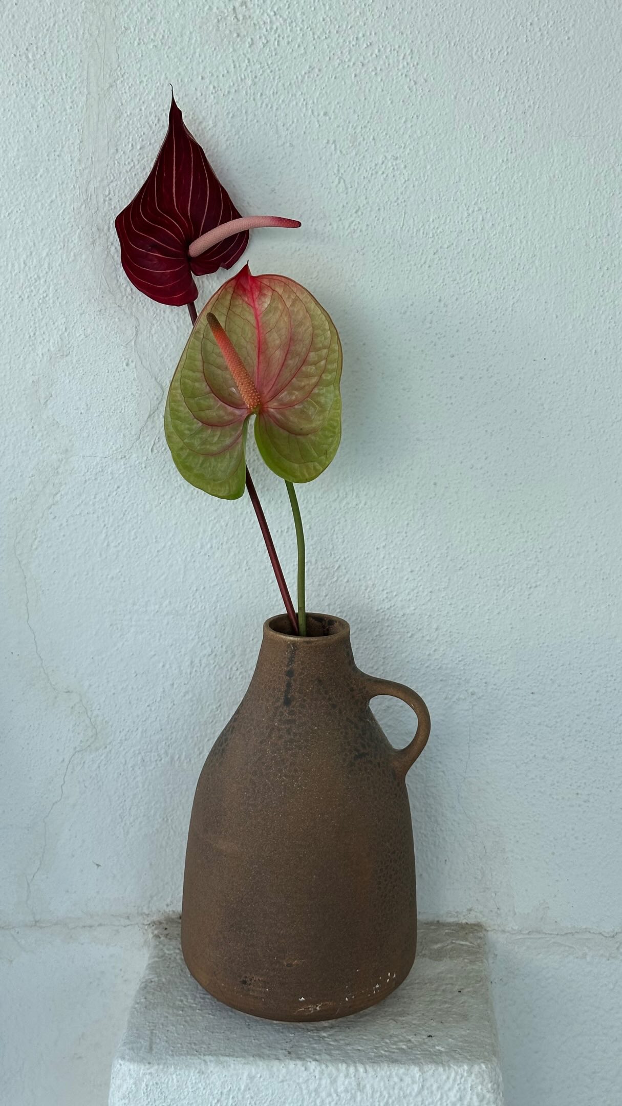 A sculptural flower in a ceramic vessel