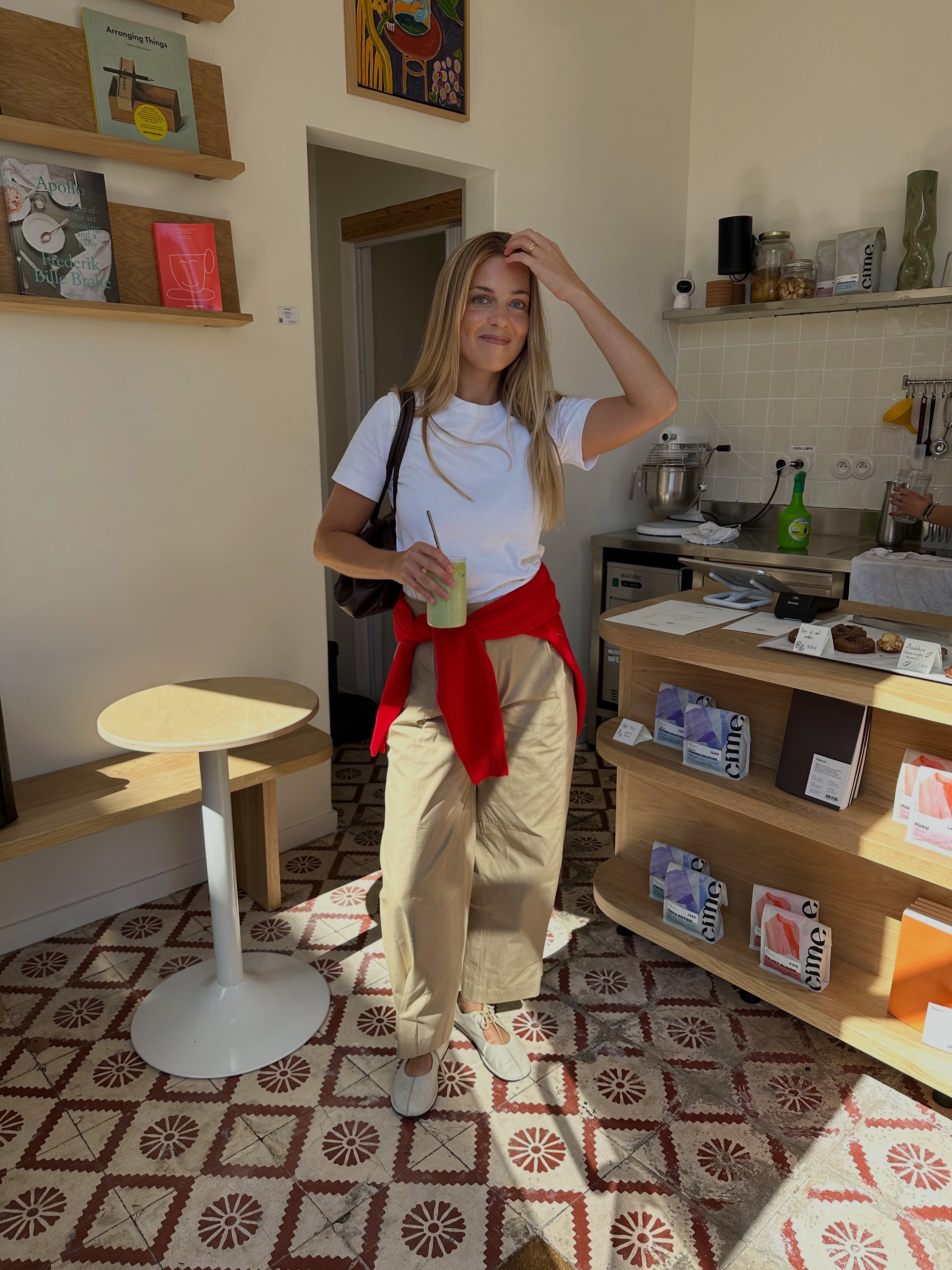 Maria standing inside a café